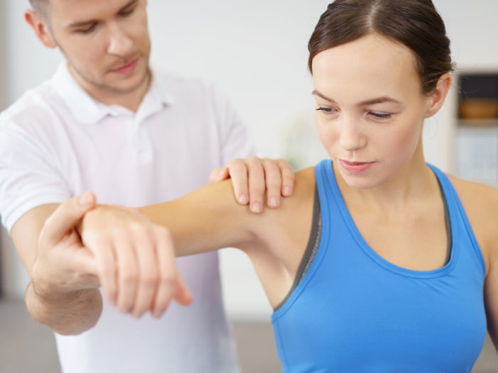 Woman having shoulder pain treatment