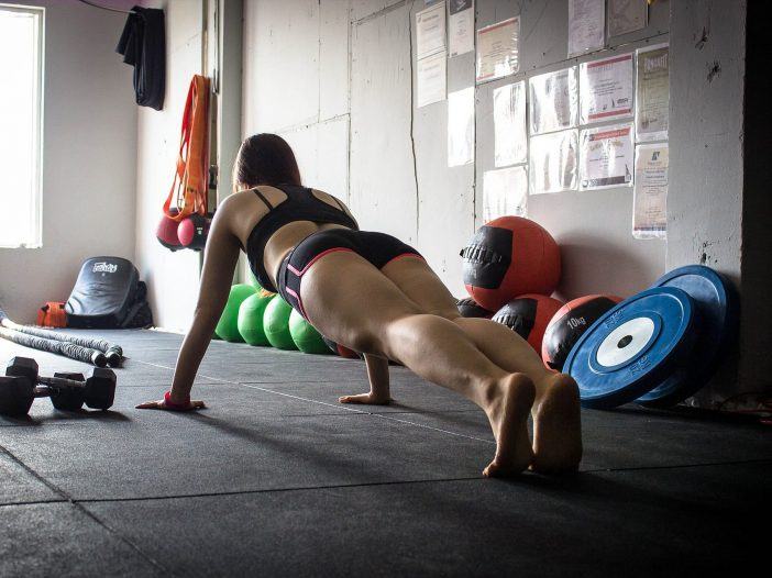 Woman doing the plank exercise at the gym